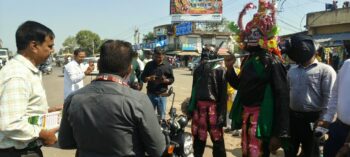 Road safety campaign at Daladili Chowk in Ranchi; 'Yamraj' explains the importance of wearing a helmet.